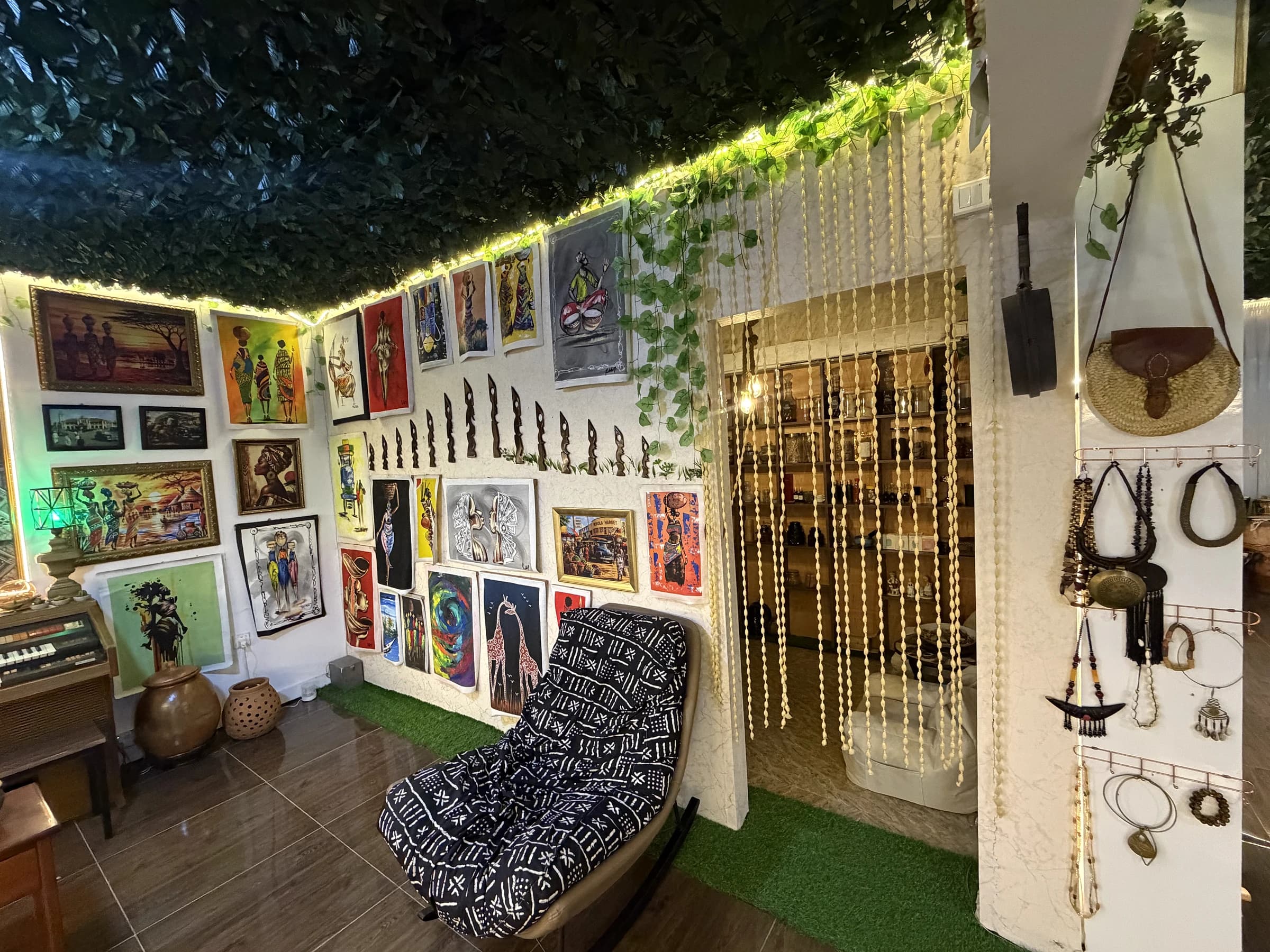 Art-filled corner with a patterned chair and hanging beads