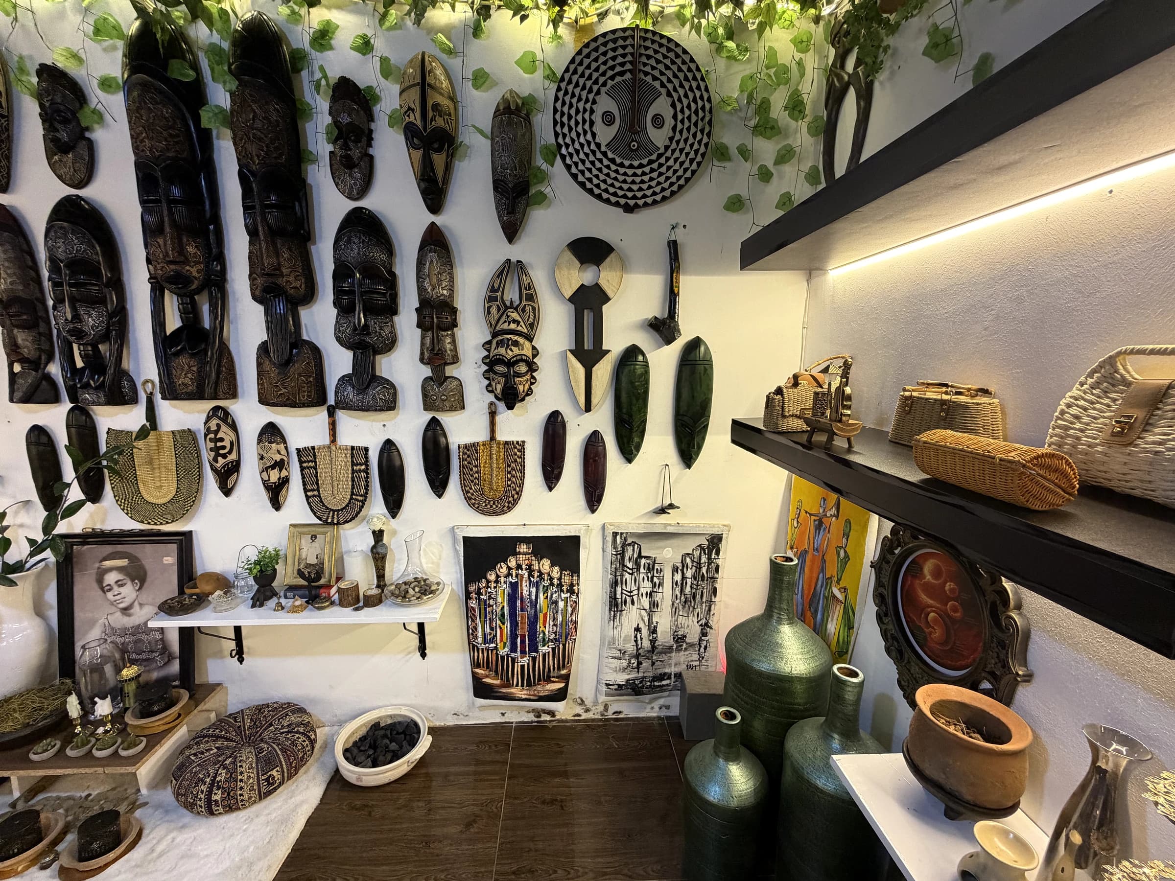 Masks and cultural objects arranged across the showroom wall