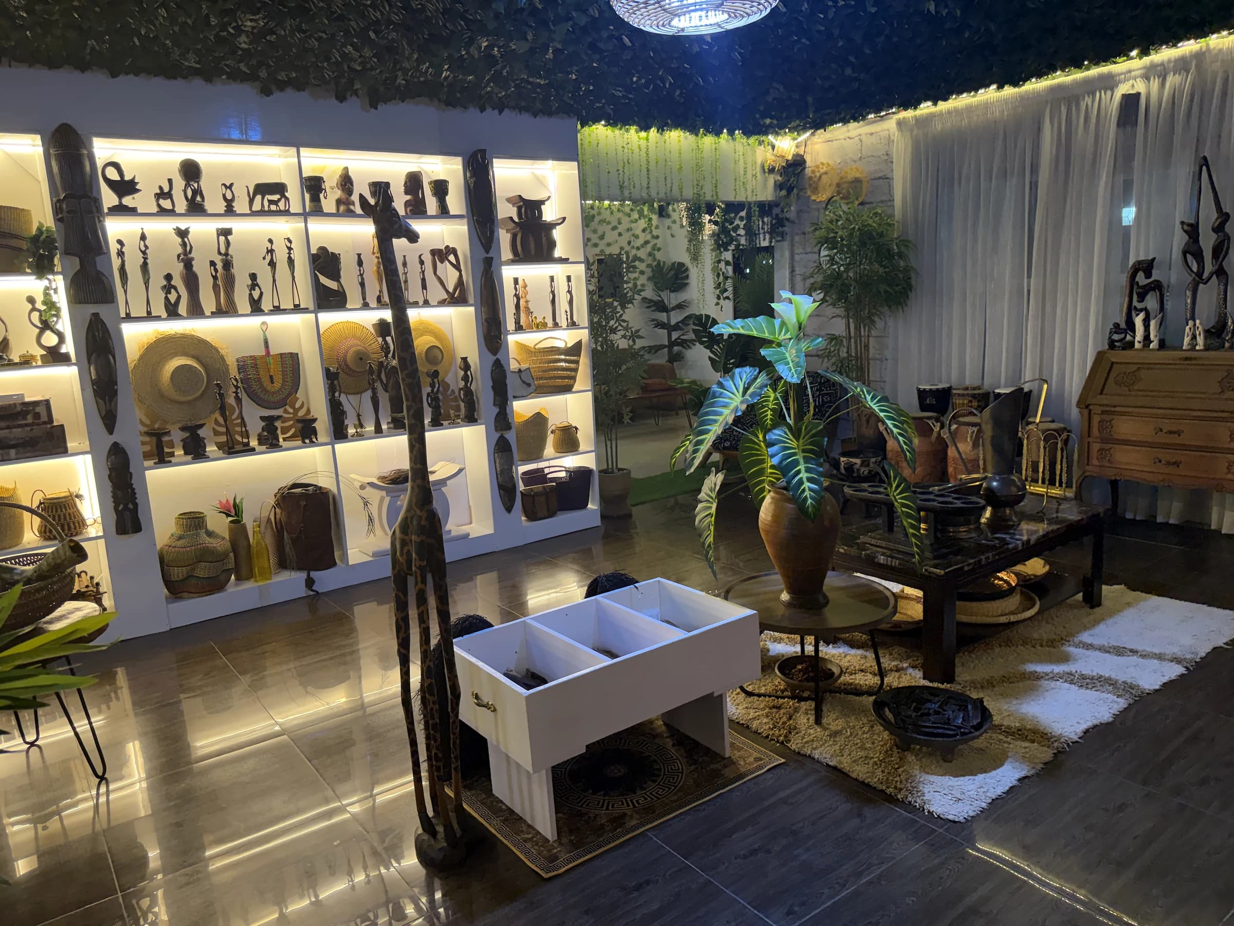 Showroom with illuminated shelves of sculpture and craft